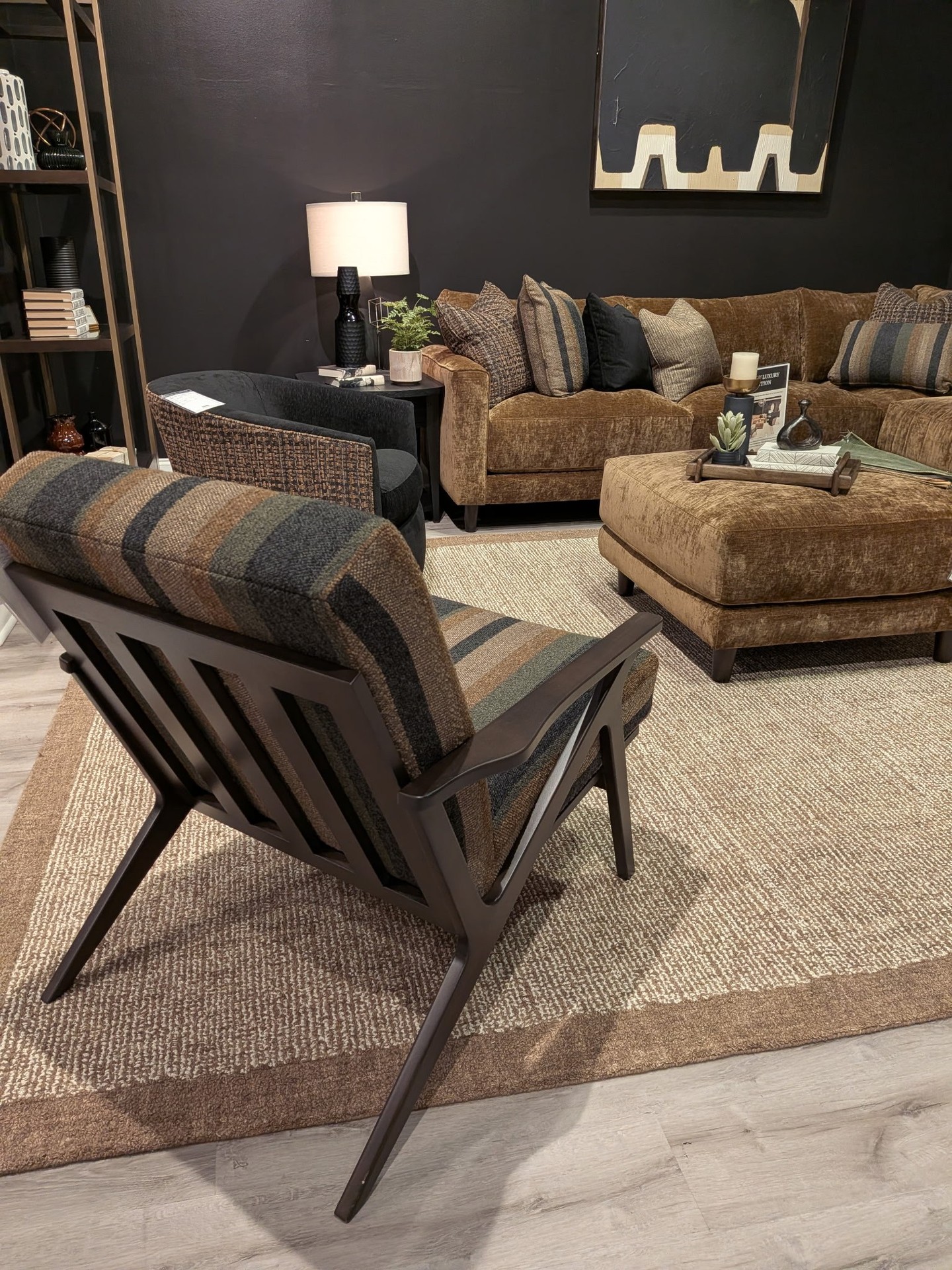 Get ready for kick-off in this moody and cozy lounge. With its deep bronze velvet sectional and warm lighting, it’s the ultimate hideaway for friends to hang out, get comfy, and watch the big game. All that's missing are the snacks!

#CraftedbyCraftmaster #CraftmasterFurniture #FromtheHeartofNC #CustomFurniture #CozyMoody